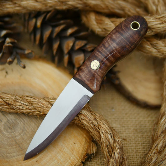 An Adventure Sworn Walker Bushcraft Knife with dark brown curly maple handle scales and thick maroon liners.