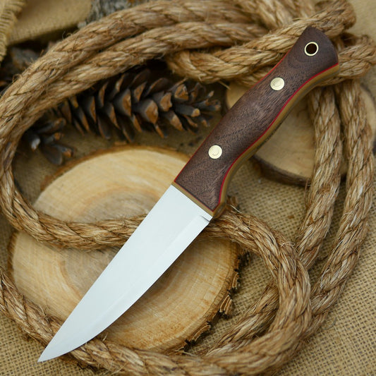 An Adventure Sworn bushcraft knife with walnut handle scales and thick bone linen micarta and thin red liners.