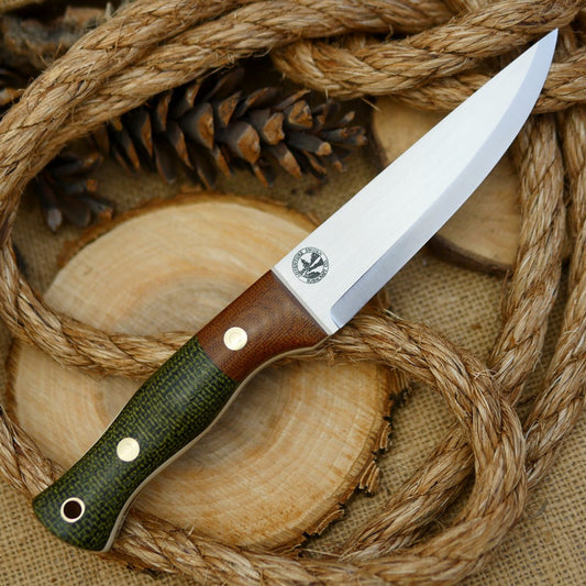 An Adventure Sworn bushcraft knife with evergreen burlap handle scales and natural brown canvas micarta bolster.